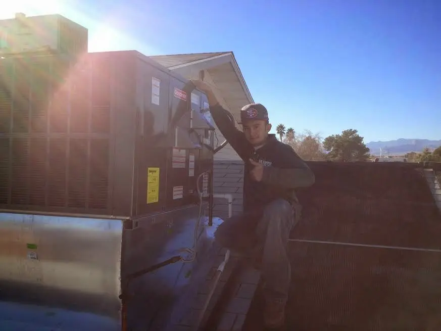 HVAC technician performing HVAC Inspection on a rooftop unit in Folcroft